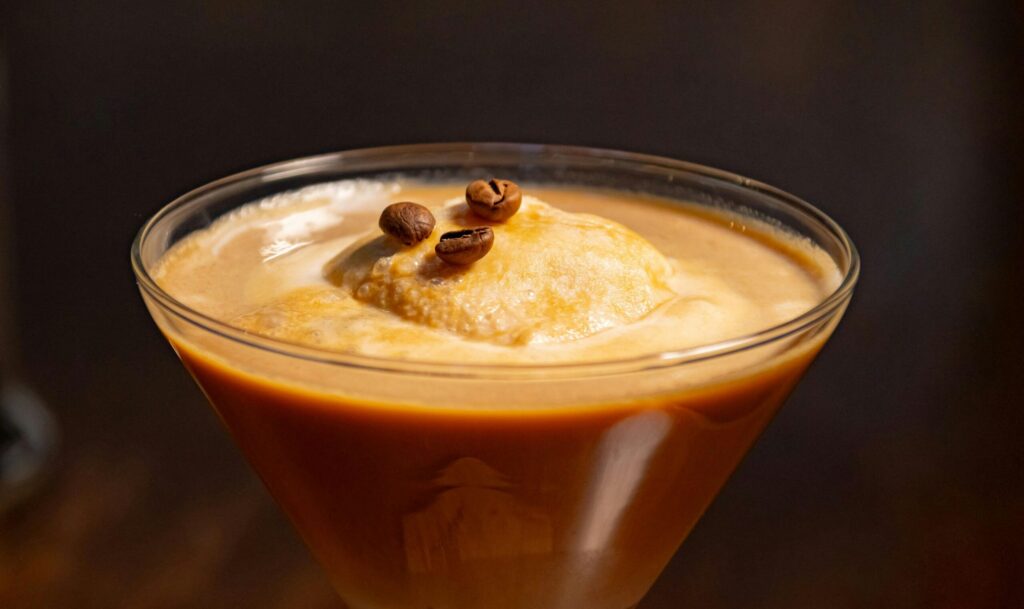 Smooth and creamy coffee drink with a scoop of ice cream, garnished with coffee beans.